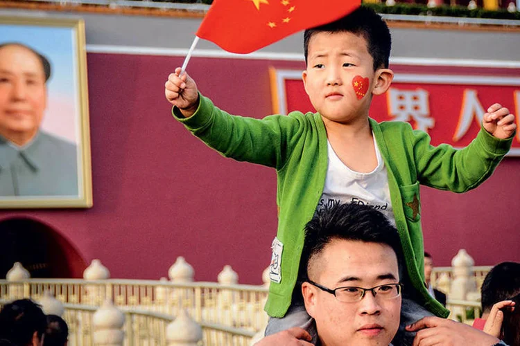 
	Fam&iacute;lia em Pequim: a economia que ser&aacute; herdada pelo filho &eacute; uma inc&oacute;gnita
 (Imagechina/AFP Photo)