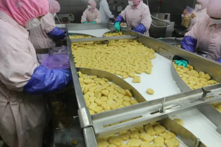 Empregados trabalham em empresa que fornece carne para redes de fast food, na China (Stringer/Reuters)