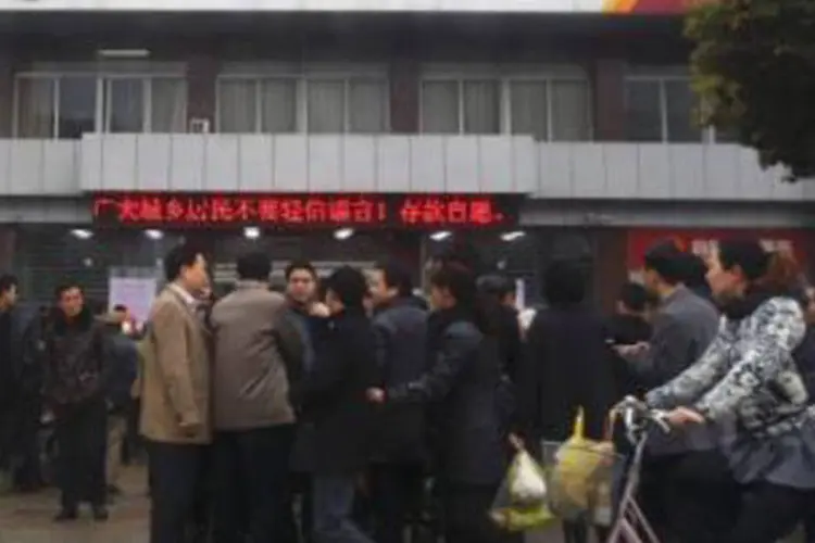 Fila em frente a banco na China: dúzias de pessoas formavam uma fila do lado de fora de uma agência do Rural Commercial Bank of Huanghai, um dos dois bancos que sofreram uma corrida por saques (Carlos Barria/Reuters)