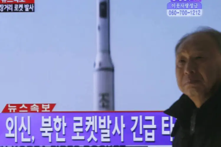 
	Sul-coreano passa por televis&atilde;o que exibe uma reportagem sobre o lan&ccedil;amento do foguete de longa dist&acirc;ncia pela Coreia do Norte
 (REUTERS / Lee Jae-Won)