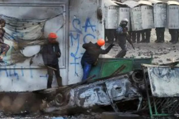 Manifestantes ucranianos se confrontam com a polícia, no centro de Kiev: ministro russo considerou que a situação na Ucrânia está se descontrolando (Genya Savilov/AFP)