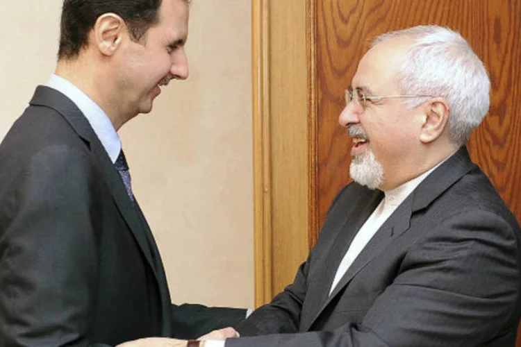Bashar al-Assad (E), com Mohammad Javad Zarif: o Irã apoia o presidente Assad (SANA/Handout via Reuters)