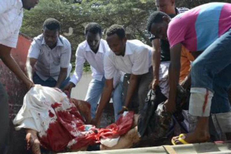 Funcionários recebem o corpo de um dos três médicos sírios que morreram: corpos foram levados para um hospital da capital somali (Mohamed Abdiwahab/AFP)