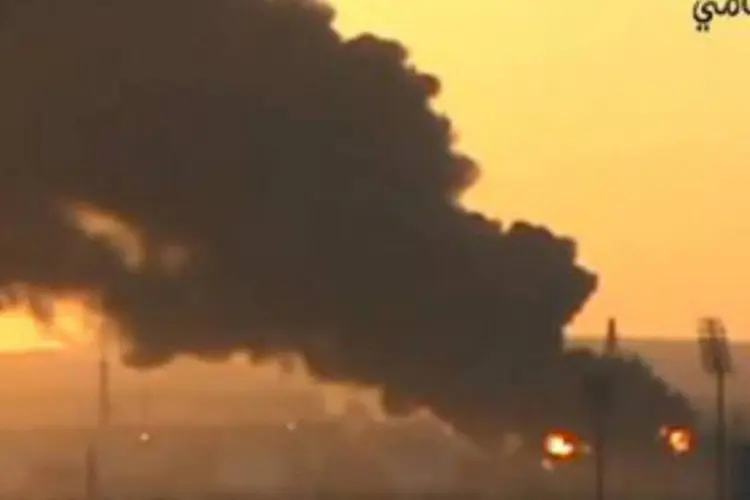 
	Fuma&ccedil;a e chamas saindo de uma refinaria atacada por rebeldes s&iacute;rios: atentado foi cometido em um bairro de maioiria alau&iacute;ta
 (DSK/AFP)