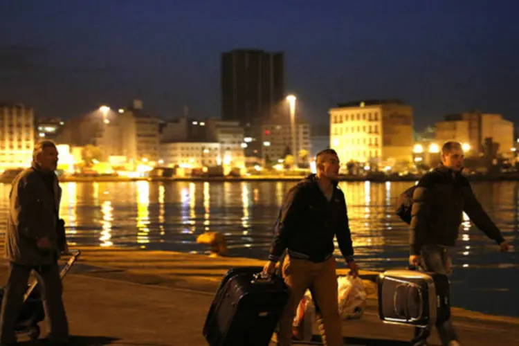 Passageiros levam bagagem através do porto de Pireus: governo do primeiro-ministro Antonis Samaras usou pela segunda vez em duas semanas os seus poderes para dissolver uma greve (Yannis Behrakis/Reuters)