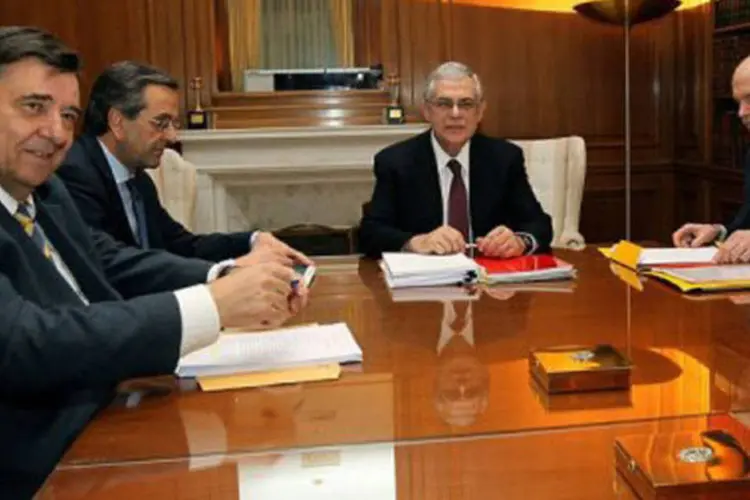 Os líderes dos três principais partidos gregos, com o primeiro-ministro ao centro e Karatzaferis, do LAOS, à esquerda
 (Orestis Panagiotou/AFP)