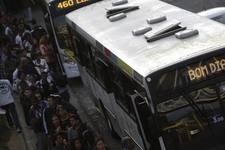 
	Fila ao lado &ocirc;nibus, em greve no RJ: sindicato patronal reafirmou que o &iacute;ndice de aumento concedido &eacute; o maior negociado este ano com rodovi&aacute;rios em todo o pa&iacute;s
 (Ricardo Moraes/Reuters)