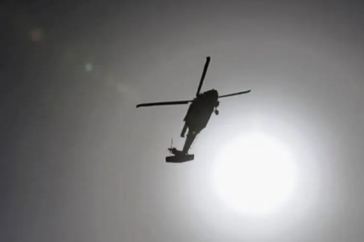 
	O helic&oacute;ptero, da empresa Columbia Helicopter Peru, caiu nas cercanias do Fundo Montecillos, no distrito de Yarinacochas, e depois explodiu
 (Shah Marai/AFP)