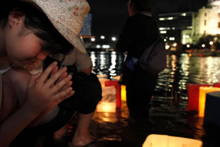 Jovem japonesa reza e relembra o aniversário de 65 anos dos ataques a cidade de Hiroshima no Japão (Kiyoshi Ota /Getty Images)