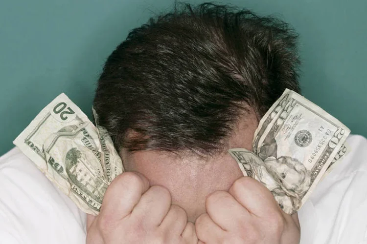 
	Homem segura dinheiro: Encare comportamentos e pensamentos negativos para melhorar o or&ccedil;amento
 (Comstock/Thinkstock)