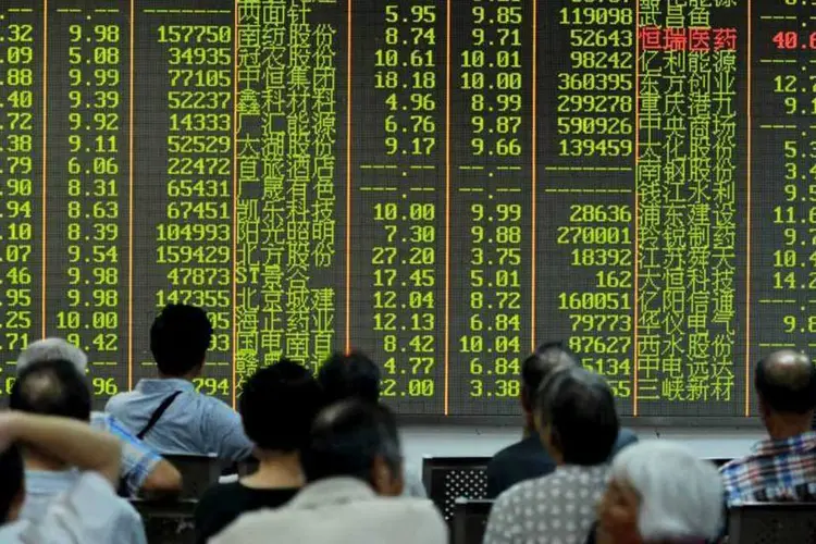 
	Investidores em Xangai, na China, em frente a painel que mostra recuo da bolsa: os n&uacute;meros verdes significam queda das a&ccedil;&otilde;es
 (REUTERS/Stringer)