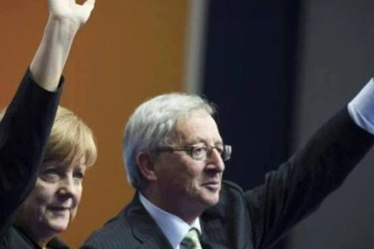 
	Angela Merkel e Juncker: nas elei&ccedil;&otilde;es de domingo, partido de Juncker se converteu no mais votado
 (AFP)