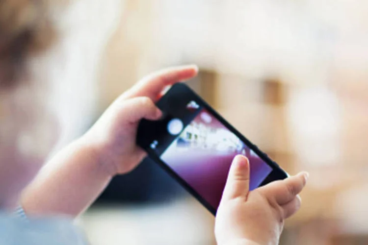 
	Crian&ccedil;a joga em smartphone: Oi n&atilde;o participou do leil&atilde;o da faixa de 700 MHz para concess&atilde;o da internet de 4G
 (Getty Images)