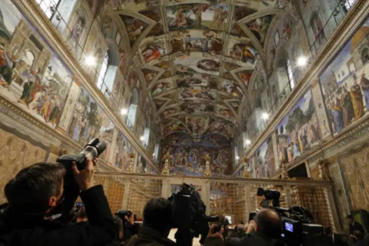 Jornalistas fazem imagens dentro da Capela Sistina, no Vaticano: conclave para a escolha do novo papa começa nesta terça-feira (REUTERS / Stefano Rellandini)