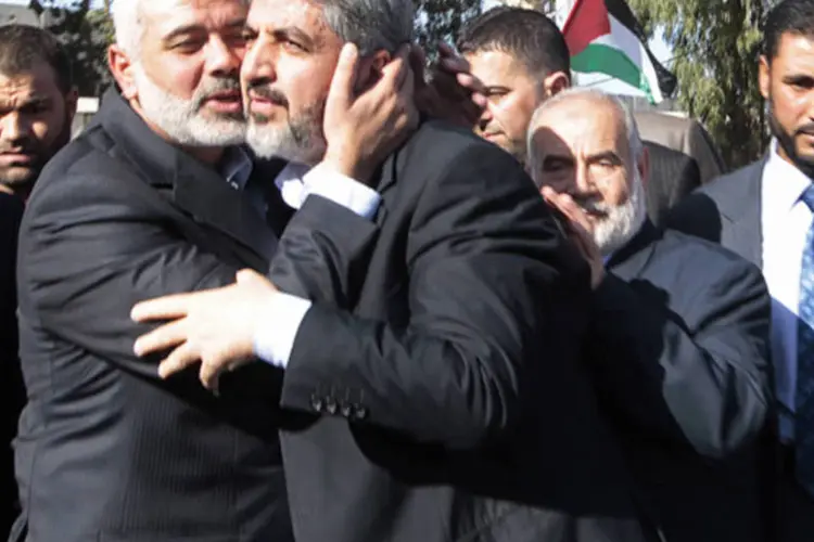 Líder sênior do Hamas, Ismail Haniyeh (e), beija o chefe do movimento islamita, Khaled Meshaal, em sua chegada a Meshaal na passagem de Rafah no sul da Faixa de Gaza  (Ahmed Jadallah/AFP)