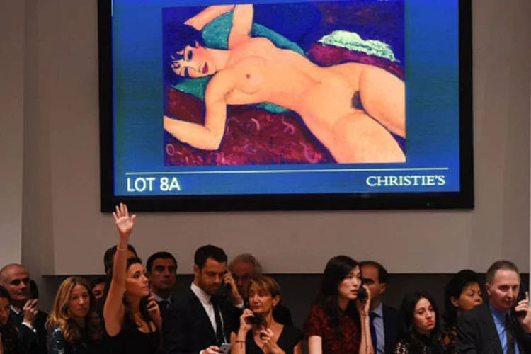 
	Leil&atilde;o do quadro Nu Couch&eacute;, de Modigliani: a tela estava avaliada em 80 milh&otilde;es de d&oacute;lares e foi arrematada em poucos minutos
 (Timothy A. ClaryAFP/Getty Images)