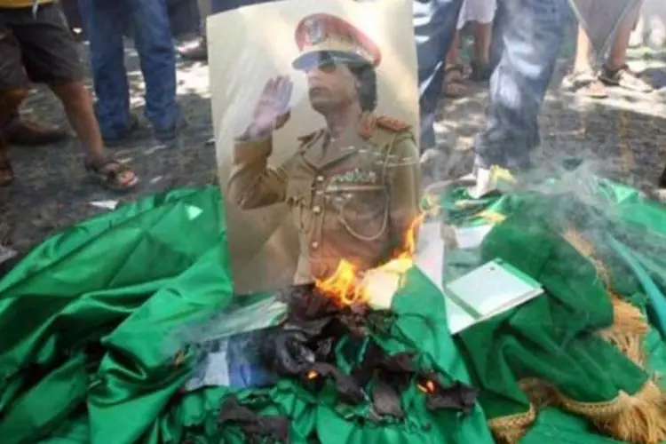Manifestantes queimam foto de Kadafi: regime tinha 10 toneladas de gás mostarda (Adem Altan/AFP)