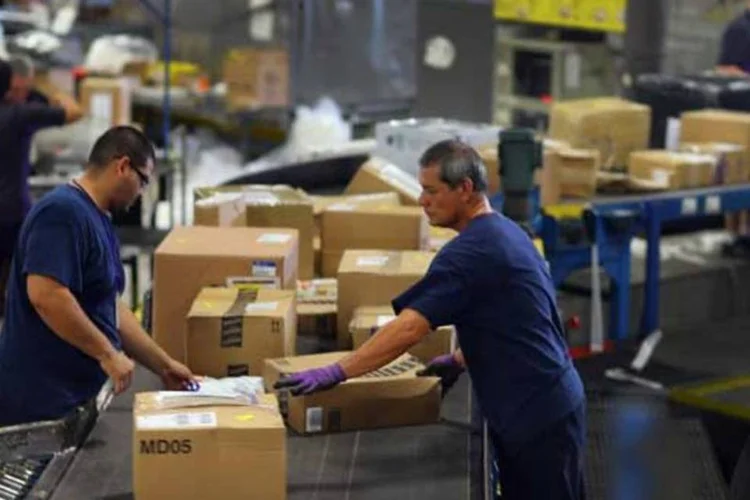 
	Trabalhadores em um centro de log&iacute;stica de um e-commerce
 (Foto/Getty Images)