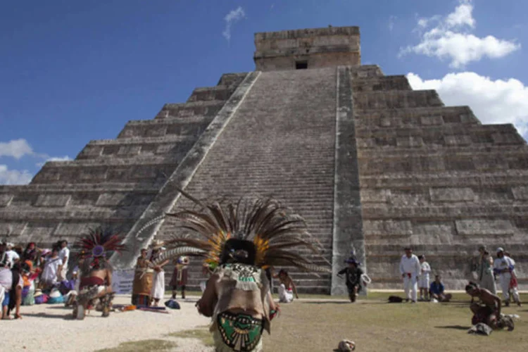 Pessoas com roupas de guerreiros astecas dançam diante da pirâmide Kukulkan, em Chichen Itza, no México (Victor Ruiz Garcia/Reuters)