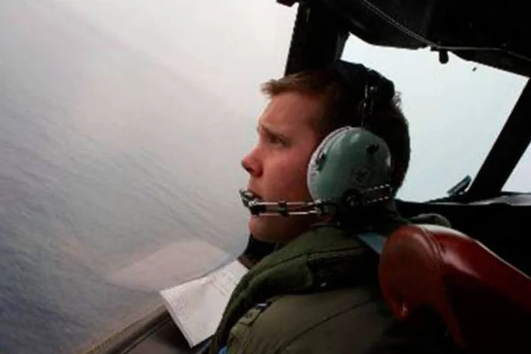 
	Co-piloto observa &aacute;rea de buscas pelo avi&atilde;o da Malaysia Airlines: a companhia a&eacute;rea confirmou que o Boeing 777, desaparecido desde 8 de mar&ccedil;o, caiu no Oceano &Iacute;ndico
 (RICHARD WAINWRIGHT/AFP)