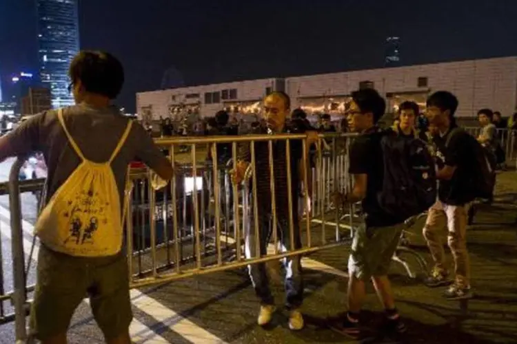 Manifestantes bloqueiam uma rua próxima à sede do governo de Hong Kong (Xaume Olleros/AFP)