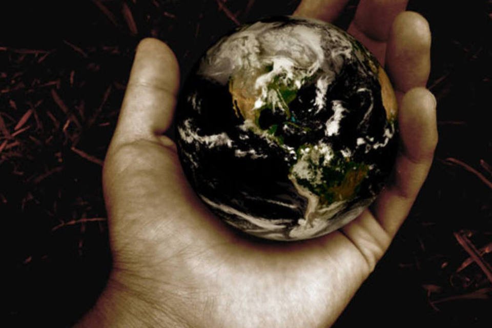 
	M&atilde;o segurando globo terrestre: livro argumenta que viveremos em mundo colaborativo
 (Stock Exchange)