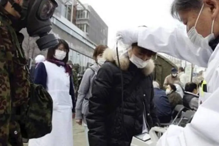Médico checa o nível de radiação de uma mulher em Nihonmatsu, no Japão (Yomiuri Shimbun/AFP)