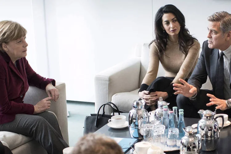 
	Merkel com Amal e George Clooney: na v&eacute;spera, o astro de 54 anos apresentou na capital alem&atilde; seu novo filme, &quot;Ave, C&eacute;sar&quot;, dos irm&atilde;os Coen
 (Guido Bergmann / Reuters)