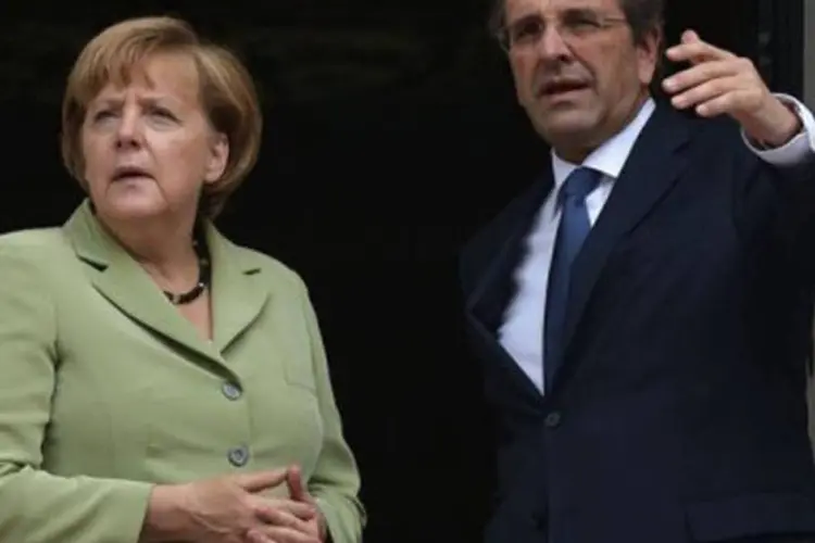 
	Merkel conversa com o premi&ecirc; grego, Antonis Samaras: ele assegurou que&nbsp;&quot;a Gr&eacute;cia est&aacute; decidida a realizar as reformas necess&aacute;rias&quot;, mas pediu &quot;um pouco de oxig&ecirc;nio&quot;
 (Aris Messinis/AFP)