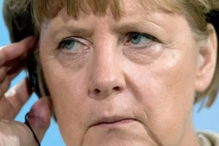 Angela Merkel em coletiva de imprensa em Berlim no dia 4 de outubro
 (Hannibal Hanschke/AFP)
