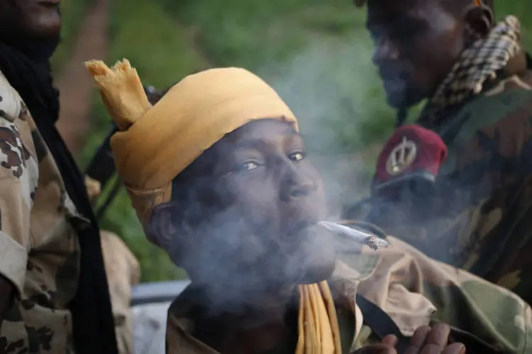
	Militante do grupo rebelde Seleka fuma um cigarro, pr&oacute;ximo da fronteira da Rep&uacute;blica Centro-Africana com o Congo
 (Goran Tomasevic/Reuters)