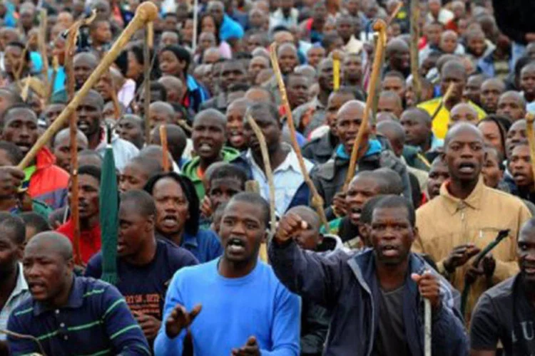 
	Mineiros protestam: embora tenha levado mais de sete anos, a improv&aacute;vel uni&atilde;o entre endinheirados advogados dos EUA e africanos pobres finalmente est&aacute; obtendo algum sucesso
 (Alexander Joe/AFP)