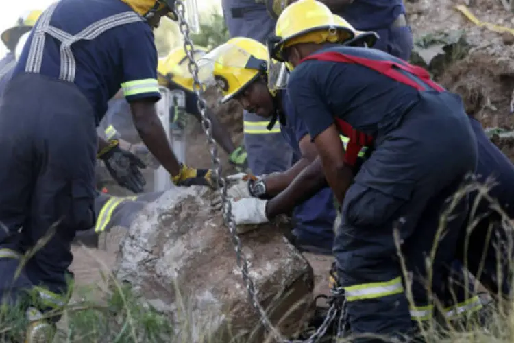 
	Equipe retira pedra durante opera&ccedil;&atilde;o de resgate de mineiros na &Aacute;frica do Sul: a mina &eacute; propriedade da empresa chinesa Gold One
 (Mike Hutchings/Reuters)
