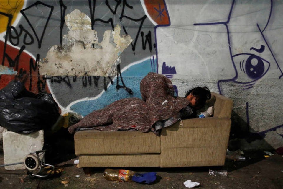Moradores de rua tentam driblar frio se juntando para dormir