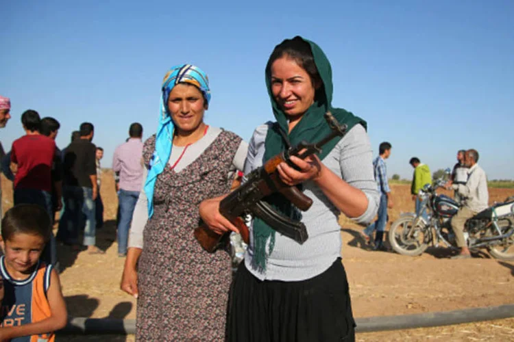 Mulher curda com AK-47: mulheres representam pelo menos 35% das forças curdas, segundo a Al Jazeera (Stringer/Getty Images)