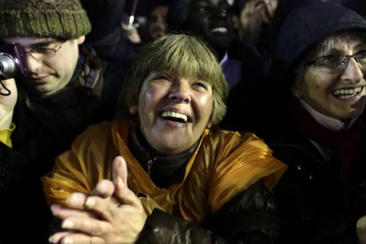 
	Multid&atilde;o se emociona com fuma&ccedil;a branca:&nbsp;as pessoas presentes na pra&ccedil;a se abra&ccedil;am, choram e se dirigem rumo &agrave; Bas&iacute;lica onde est&aacute; a janela da qual o novo papa pronunciar&aacute; suas primeiras palavras ao mundo como pont&iacute;fice.
 (REUTERS/Kevin Coombs)