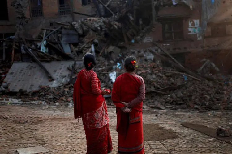 
	Mulheres observam pr&eacute;dio derrubado por terremoto em Bhaktapur, no Nepal: os tremores causaram mais de 8,6 mil mortos e 16,8 mil feridos
 (REUTERS/Ahmad Masood)