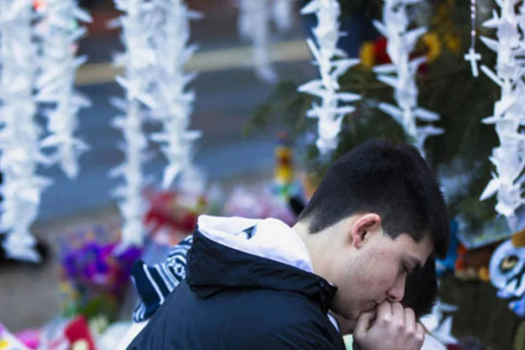 
	Homem ora em visita ao memorial das v&iacute;timas de Newtown:&nbsp;Adam Lanza n&atilde;o deixou cartas, nem era ativo em redes sociais
 (Lucas Jackson/Reuters)