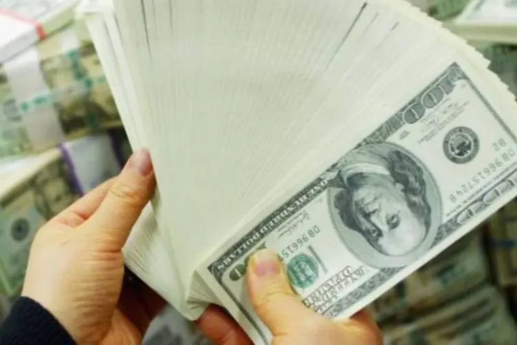 Dólar está cada vez mais perto de romper para baixo a marca de R$ 1,55 (Getty Images)