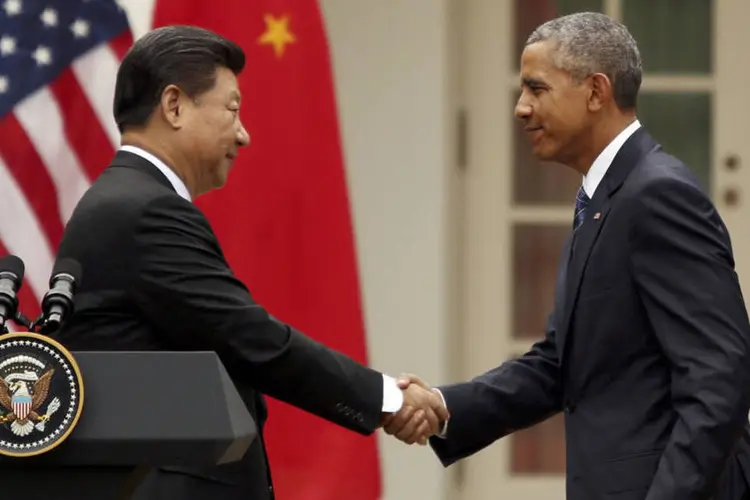 
	Obama e Xi Jinping: o acordo, anunciado ap&oacute;s cinco anos de &aacute;rduas negocia&ccedil;&otilde;es, ainda precisa ser assinado e ratificado pelos 12 pa&iacute;ses
 (Reuters / Gary Cameron)