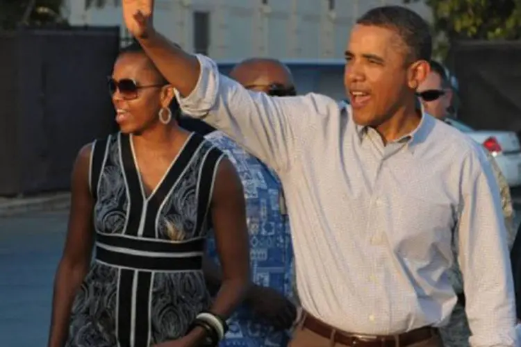Obama e a primeira-dama Michelle Obama: 'em alguns aspectos, agora sou mais otimista que quando concorri pela primeira vez'
 (Mandel Ngan/AFP)