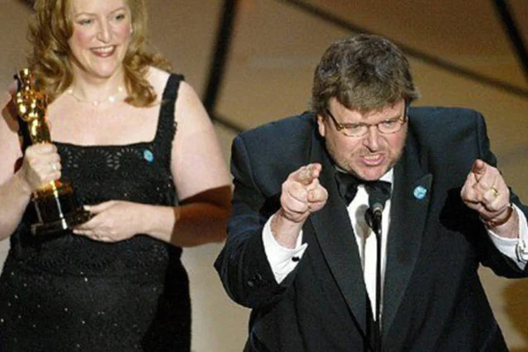 Michael Moore critica George W. Bush em seu discurso de vitória por "Tiros em Columbine" no Oscar de 2003. (©AFP/Arquivo / TIMOTHY A. CLARY)