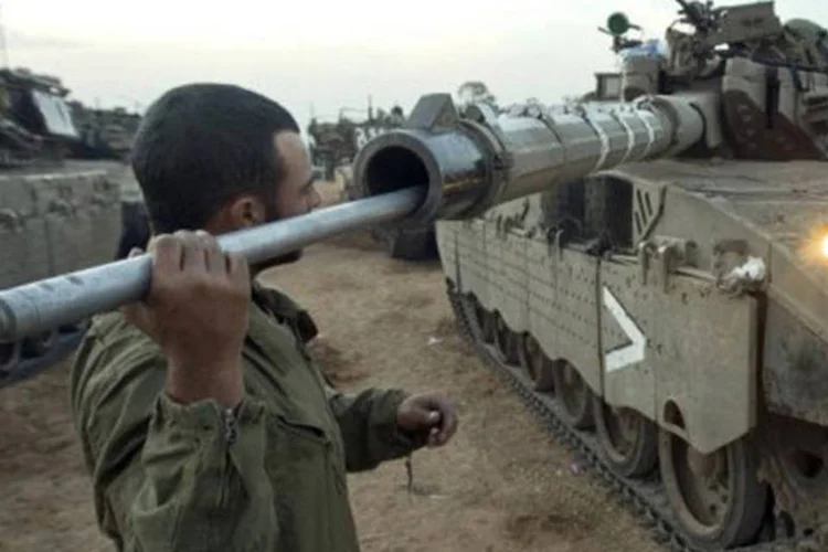 
	Soldado israelense limpa tanque perto da fronteira com a Faixa de Gaza: houve disparos israelenses perto da fronteira
 (Jack Guez/AFP)