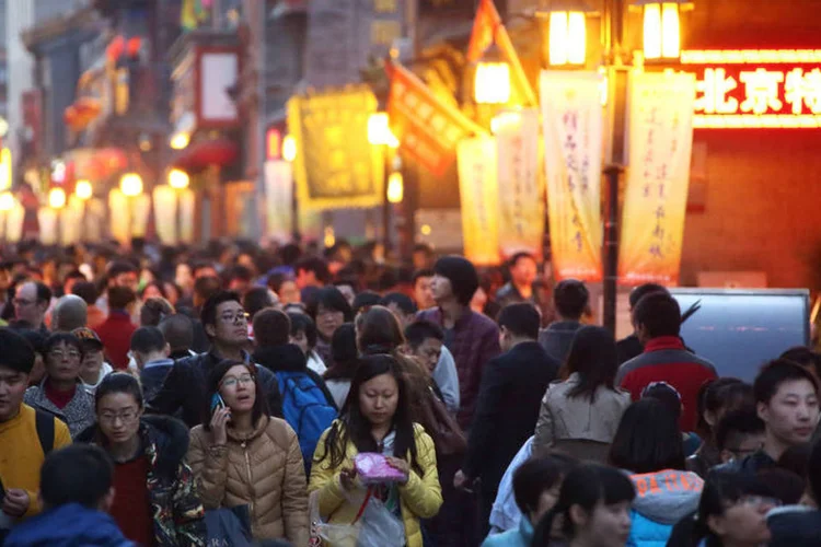 Pedestres caminham em rua comercial de Beijing, na China (Tomohiro Ohsumi/Bloomberg)