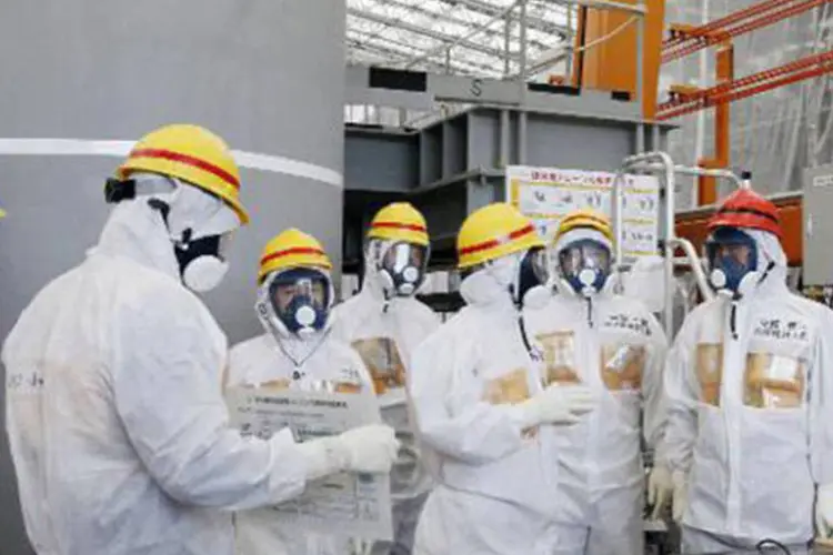 Primeiro-ministro japonês, Shinzo Abe (d), na usina nuclear de Fukushima: incidente teria sido causado por um corte da alimentação elétrica dessa bomba feito por engano (Japan Pool/AFP)