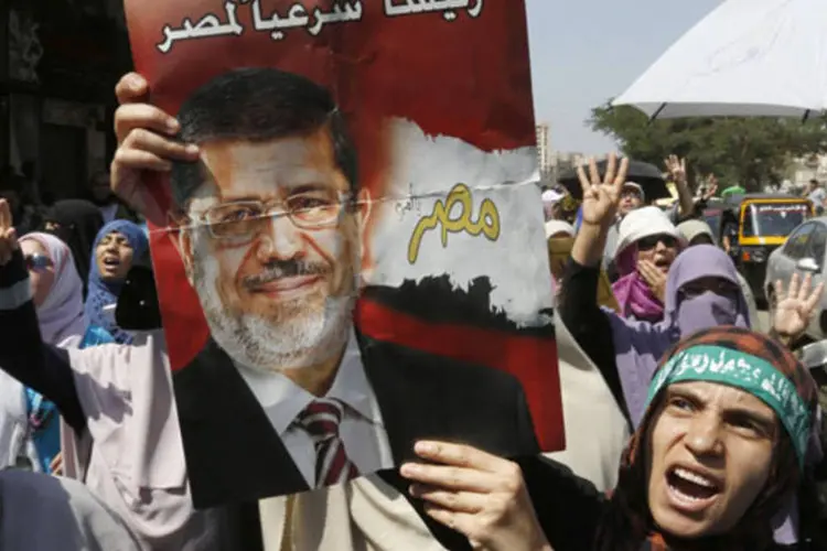
	Apoiadores de Mohamed Mursi no Egito: segundo a ag&ecirc;ncia estatal de not&iacute;cias &#39;Mena&#39;, Mursi e os l&iacute;deres s&atilde;o acusados de instigar os atos de viol&ecirc;ncia de 5 de dezembro
 (Louafi Larbi /Reuters)
