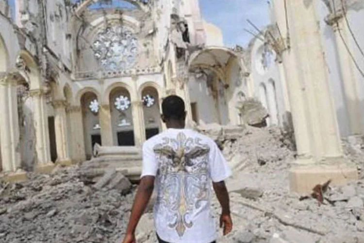 Homem caminha pelas ruínas de catedral no Haiti: o país precisa de 20 bilhões de dólares em investimentos diretos durante cinco a 10 anos, disse especialsta (AFP)