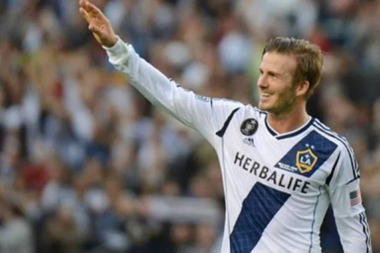 
	Beckham acena em sua &uacute;ltima partida pelo Los Angeles Galaxy: ap&oacute;s anunciar sua sai&iacute;da, o meia informou a inten&ccedil;&atilde;o de procurar &quot;um &uacute;ltimo desafio&quot; antes de se aposentar&nbsp;
 (Robyn Beck/AFP)