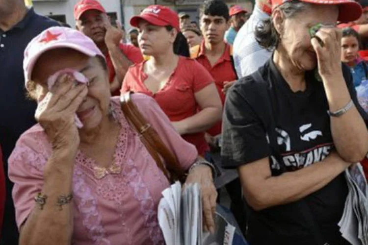 
	Simpatizantes de Ch&aacute;vez se emocionam:&nbsp;antes de partir a Havana, o l&iacute;der venezuelano nomeou o vice-presidente Nicol&aacute;s Maduro seu herdeiro pol&iacute;tico.
 (Leo Ramirez/AFP)