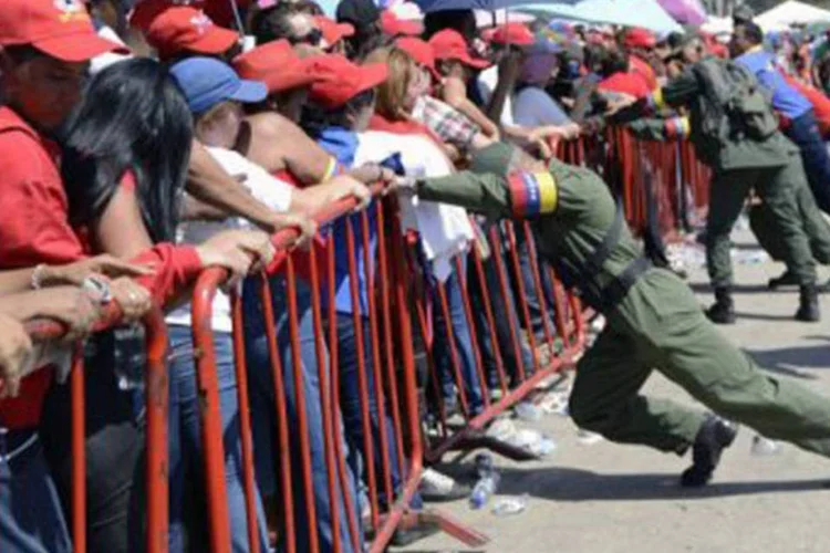 
	Simpatizantes aguardam na fila para dar o &uacute;ltimo adeus a Ch&aacute;vez, do lado de fora da Academia Militar: pessoas de todo o pa&iacute;s foram ao local se despedir do l&iacute;der
 (Leo Ramirez/AFP)